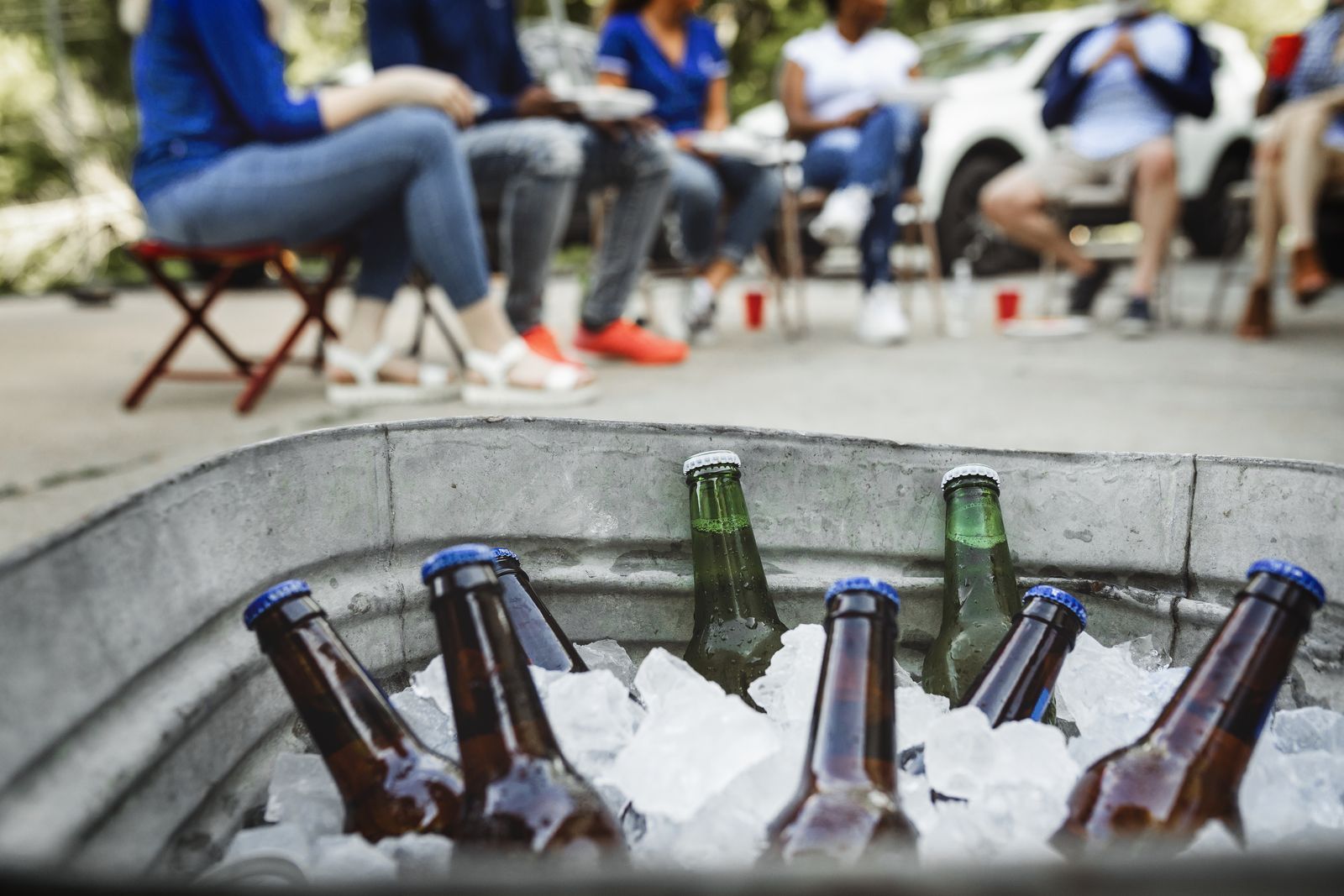 Bottled drinks chilling in a tub of ice at an outdoor event